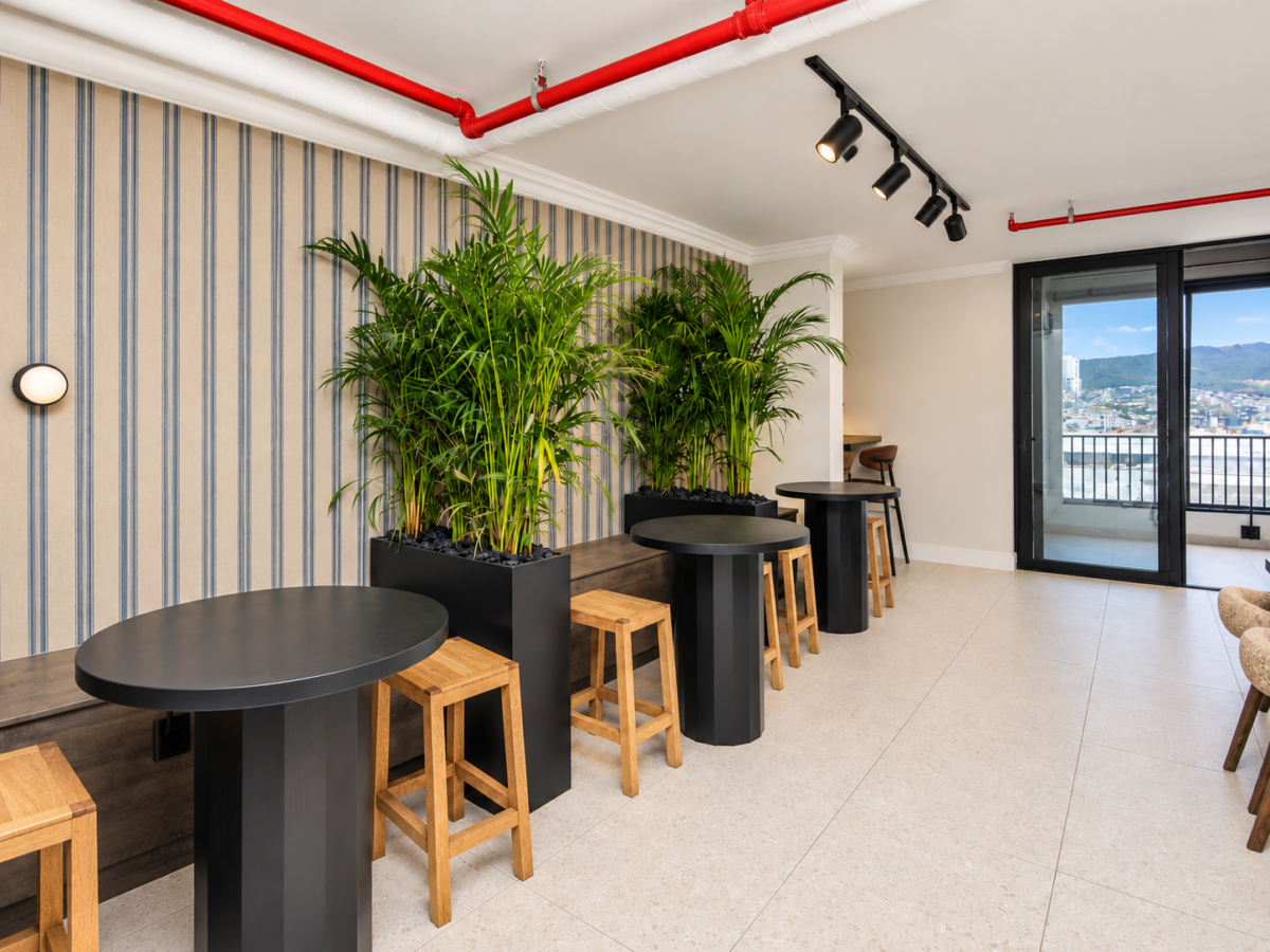 Co-working tables and indoor greenery at Maritime Place