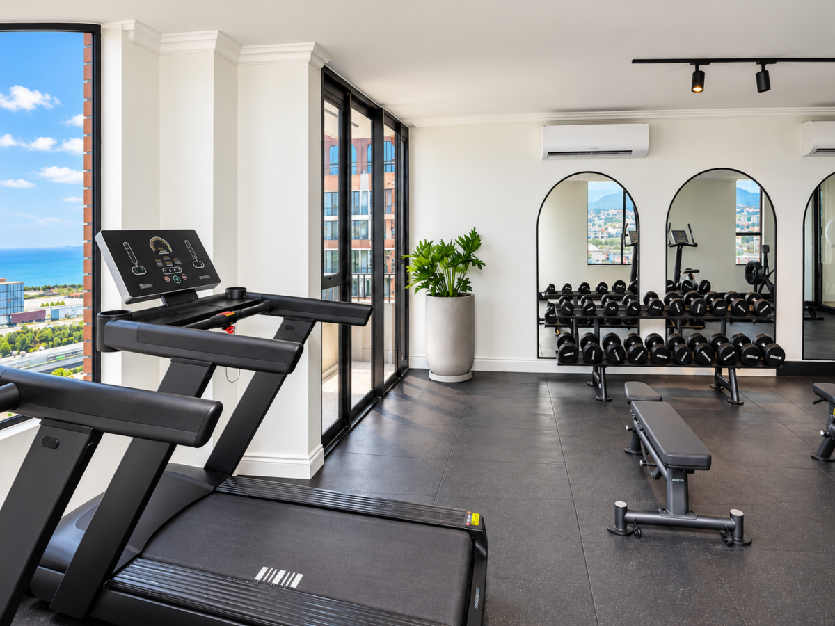 Treadmill, workout bench and free weights in the gym