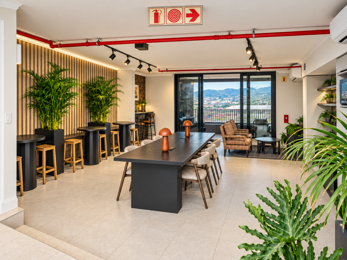 Co-working lounge with a communal table and smaller seating areas